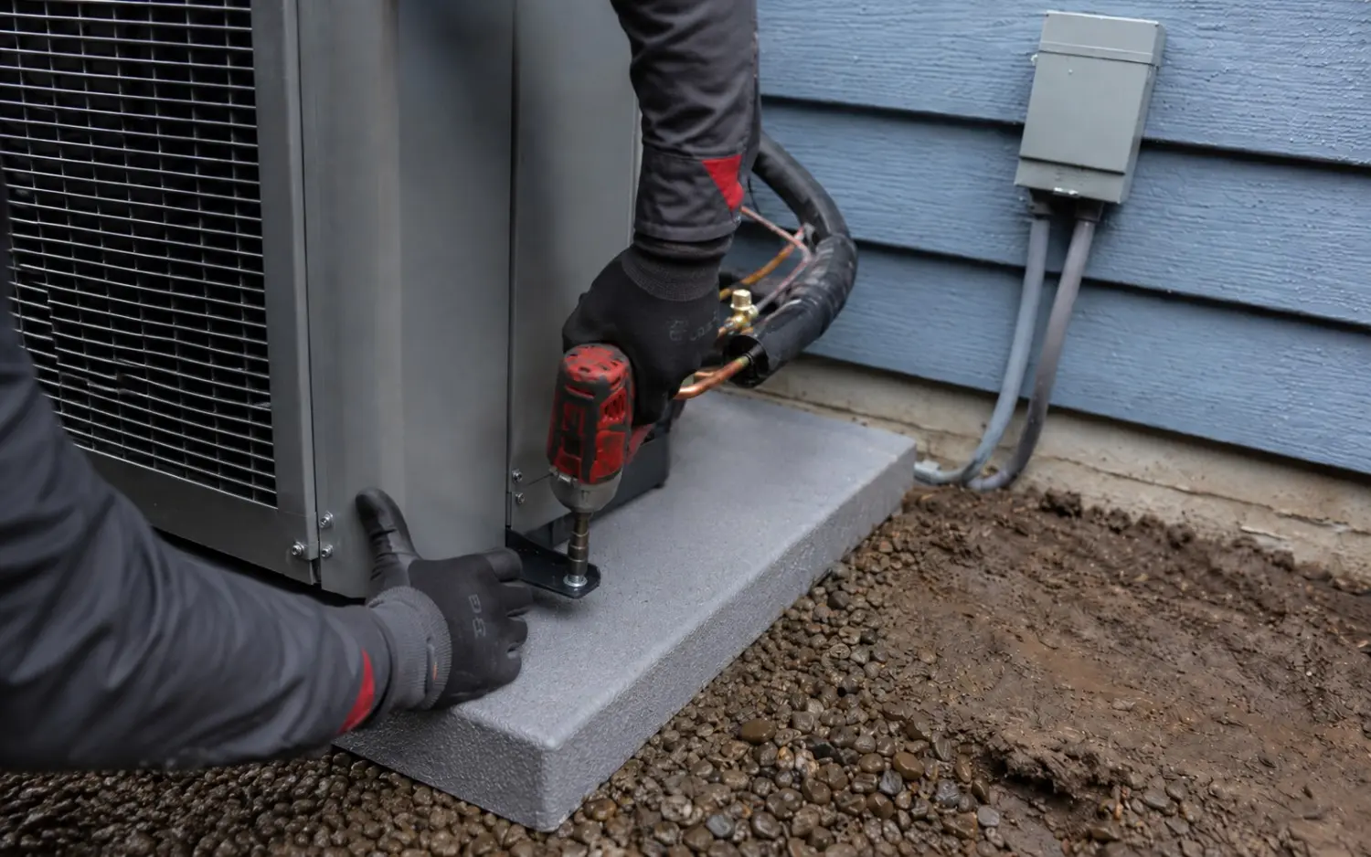 Westside Comfort Solutions technician installing a new outdoor AC condenser at a Renton, WA home